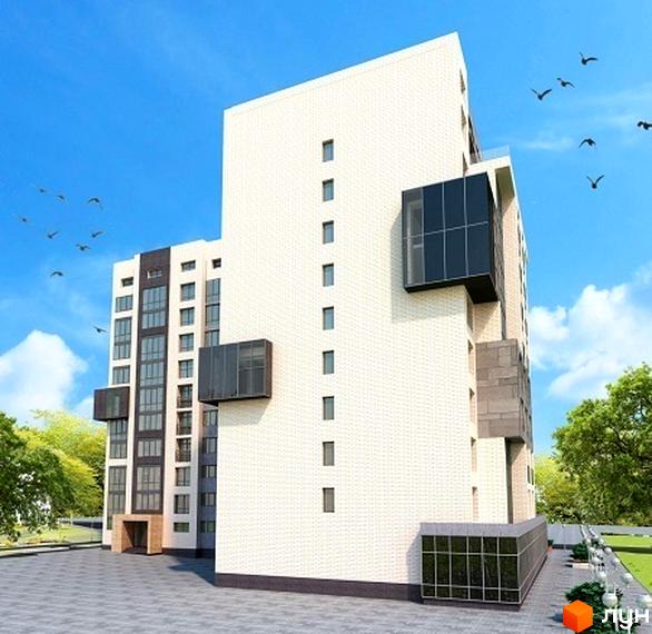 Новобудова ЖК Гармонія-2 з білою цегляною фасадною частиною та темними скляними вставками. Територія навколо будинку облаштована бруківкою та зеленими насадженнями.