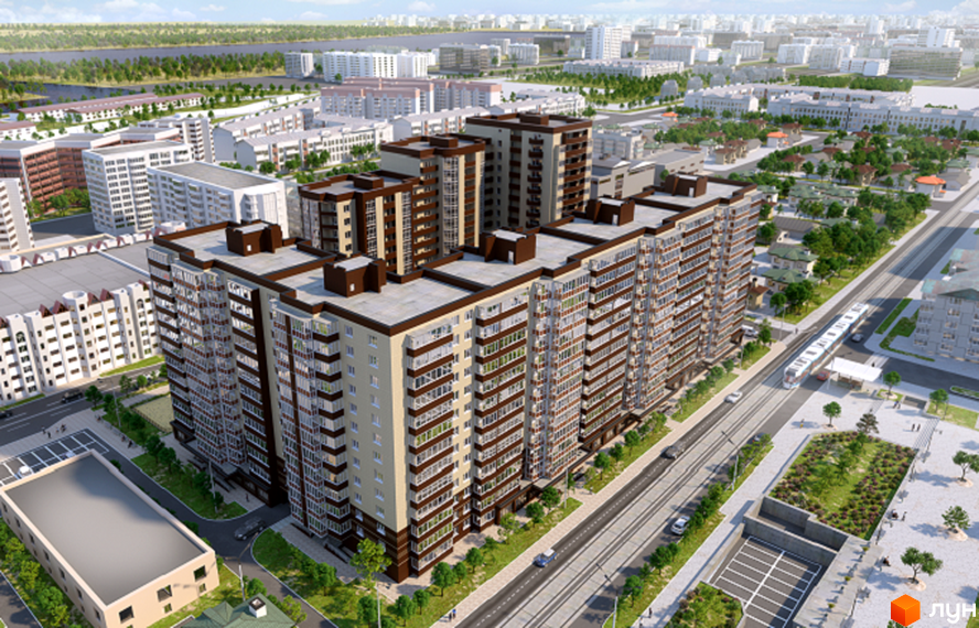 Житловий комплекс Олександрівський 2. Фотографія фасаду багатоповерхових будинків з коричневими та світлими елементами, балконами та панорамними вікнами. На прибудинковій території видно дорогу з трамвайними коліями, зелені насадження та пішохідні зони.