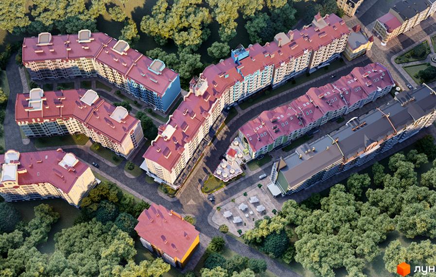Вид зверху на житловий комплекс Подол Град з червоними дахами та фасадами різних кольорів. Навколо комплексу зелені дерева та облаштована прибудинкова територія з парковкою.