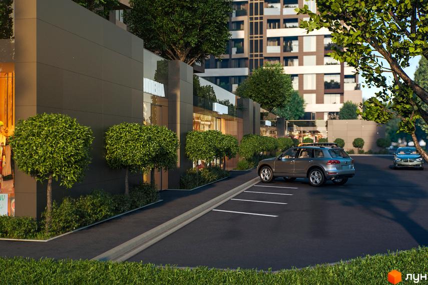 Зовнішній вигляд будівлі житлового комплексу Avalon Garden з паркуванням та зеленими насадженнями. На території комплексу розташовані дерева та кущі.