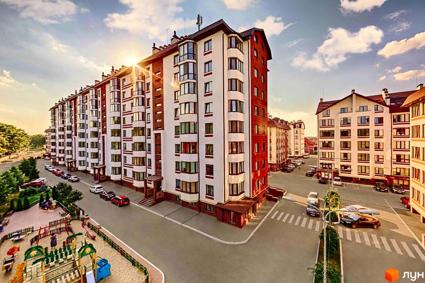 Житловий комплекс Празький квартал з біло-червоними фасадами та балконами. На території облаштовано дитячий майданчик та паркувальні місця.