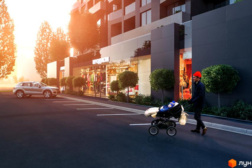 Зовнішній вигляд будівлі ЖК Avalon Garden з фасадом темного кольору. На передньому плані парковка та чоловік з дитячим візком.