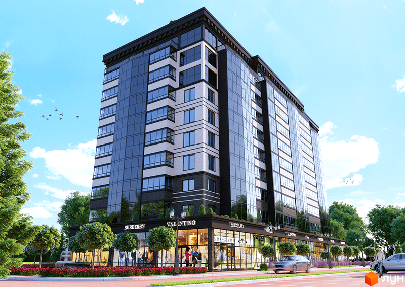 Житловий комплекс Avila DeLuxe має темний фасад зі скляними вікнами та світлими вставками. На першому поверсі розташовані магазини, а територія озеленена.