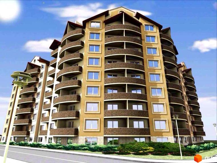 Житловий комплекс на вулиці Чорновола 22, 22а: багатоповерховий будинок світлого кольору з округлими балконами. Прибудинкова територія з озелененням та дорогою.