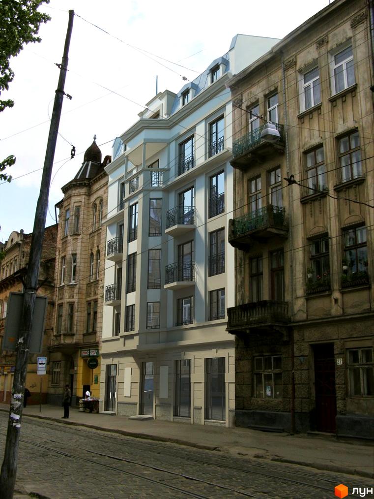 Фасад житлового комплексу на вул. Богдана Хмельницького, 27а. Будинок з балконами та вікнами виходить на бруковану вулицю з трамвайними коліями.