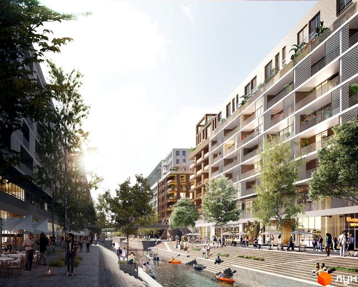 Житловий район Rybalsky з багатоповерховими будинками та балконами, що виходять на набережну з людьми та зонами відпочинку біля води.