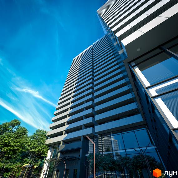 Зображення фасаду Житлового комплексу Standard One. Висотна будівля з великою кількістю балконів, панорамні вікна та зелені насадження навколо.