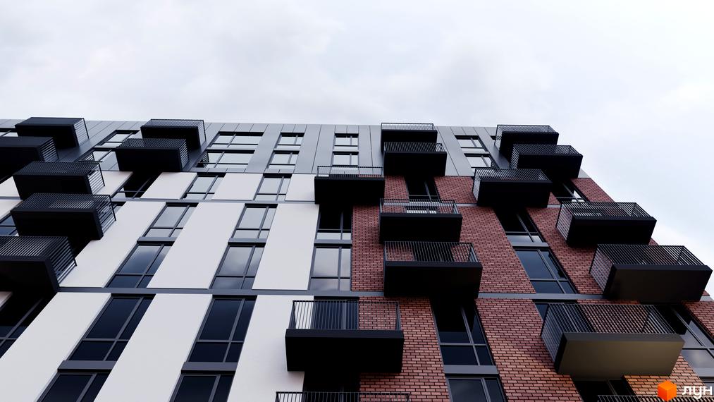 Фасад новобудови ЖК Avalon з цегляною кладкою та білими панелями. Балкони мають чорне оздоблення та металеві огорожі.