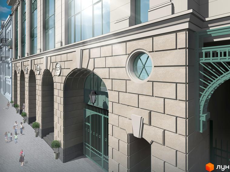 Фасад житлового комплексу Ярославів Град з арками та круглим вікном. Біля будинку розташована бруківка та зелені насадження.