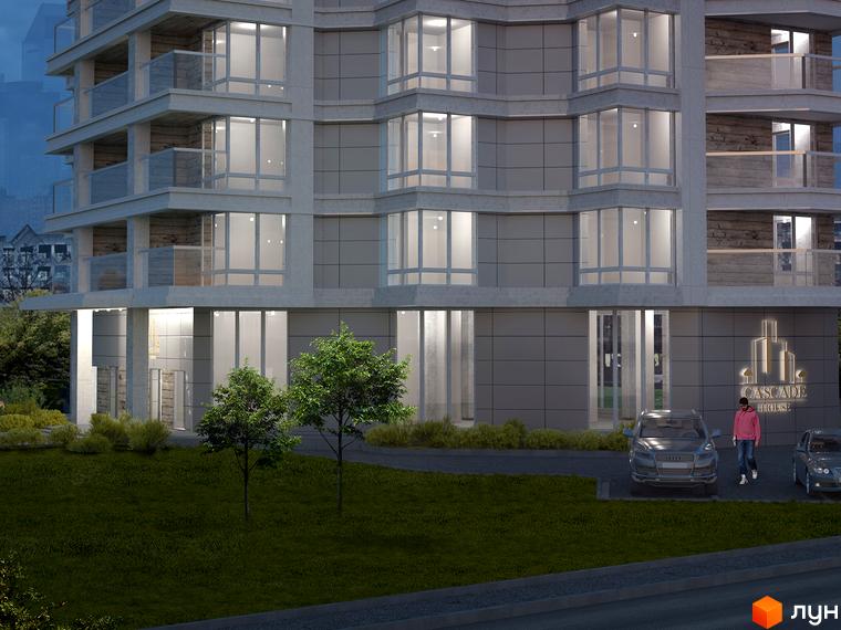 Зовнішній вигляд житлового комплексу Cascade House з фасадом з сірого каменю та великими вікнами. Прибудинкова територія з зеленим газоном та деревами.