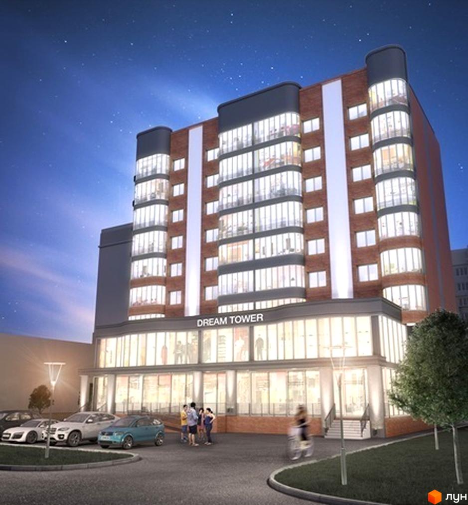 Житловий комплекс Dream Tower вночі. Багатоповерхова будівля з цегляним фасадом та великими вікнами. Перед будинком розташована парковка з автомобілями та зелена зона.