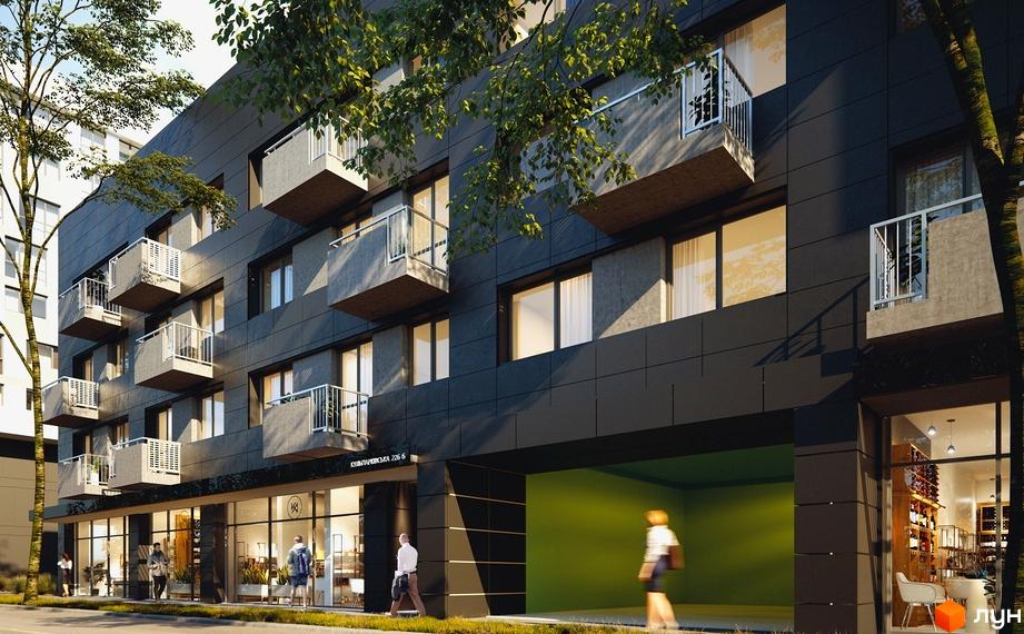 Зовнішній вигляд новобудови Місто Трав з балконами та великими вікнами. Прибудинкова територія з деревами та пішохідною зоною.