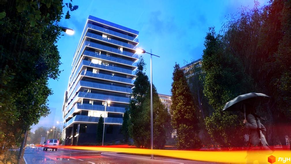 Житловий комплекс Avalon – багатоповерхова новобудова з панорамним склінням та підсвіткою фасаду, розташована біля зеленої зони та дороги з автомобілями.