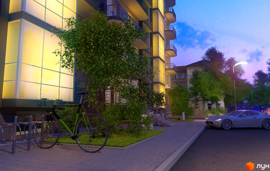 Зовнішній вигляд житлового комплексу на вул. Єрошенка, 14, з велосипедами та автомобілем біля будинку. Зелені дерева та освітлені вікна створюють затишну атмосферу.