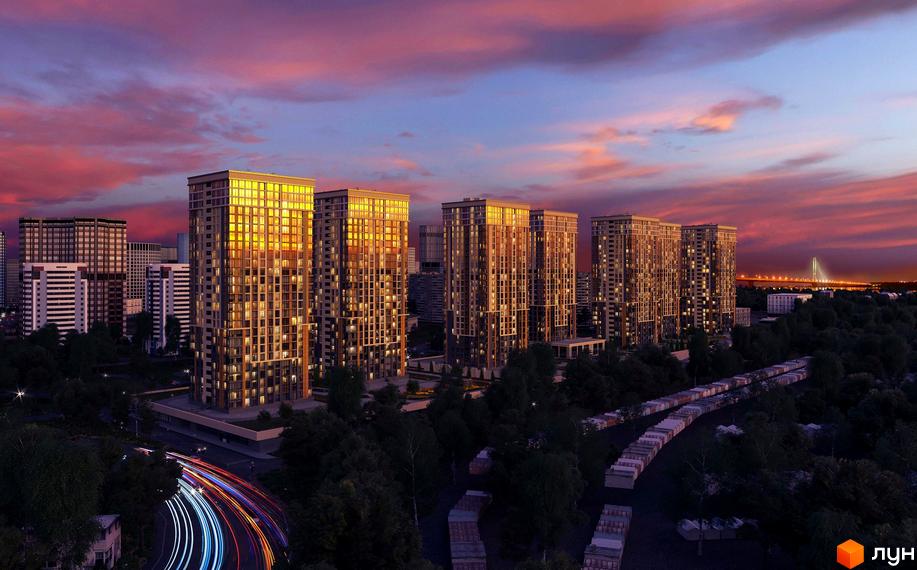 Житловий комплекс Урлівський-1: висотні будинки з панорамними вікнами на тлі вечірнього неба. Територія комплексу з деревами та дорогою з автомобілями.