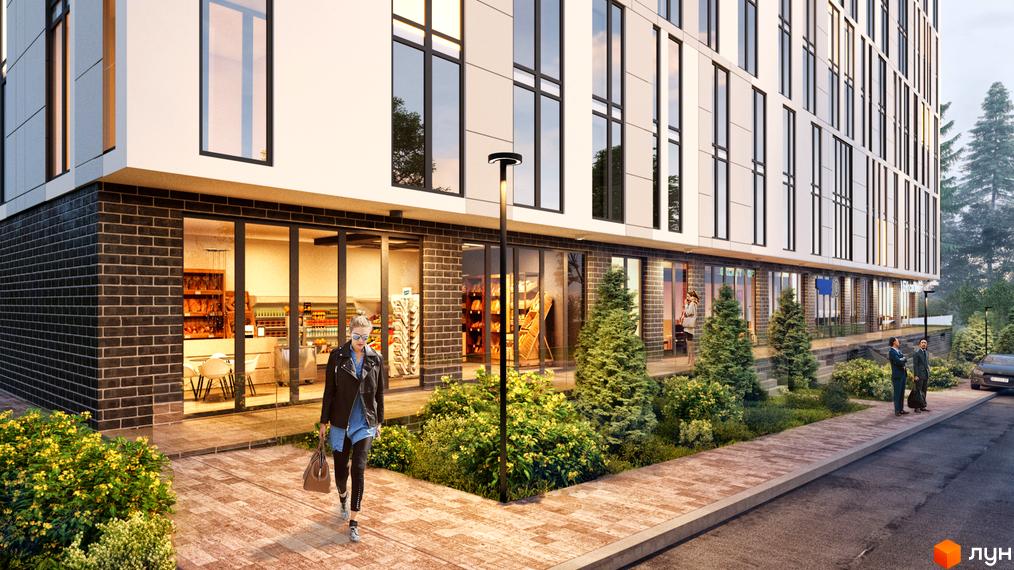 Новобудова ЖК OBRIY з цегляним цоколем та великими вікнами. Прибудинкова територія з доглянутими зеленими насадженнями та пішохідною доріжкою.