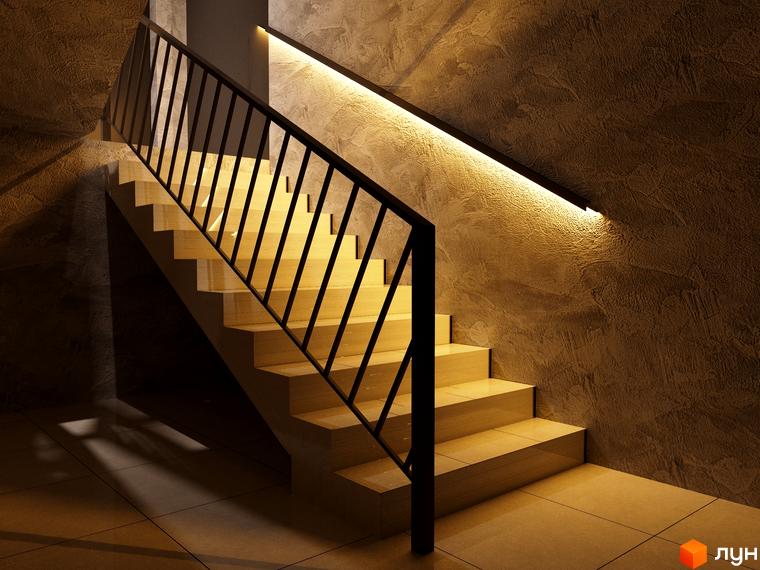 Сходи в житловому комплексі Європа з чорними поручнями та підсвічуванням. Стильні сходи ведуть до верхніх поверхів будинку.