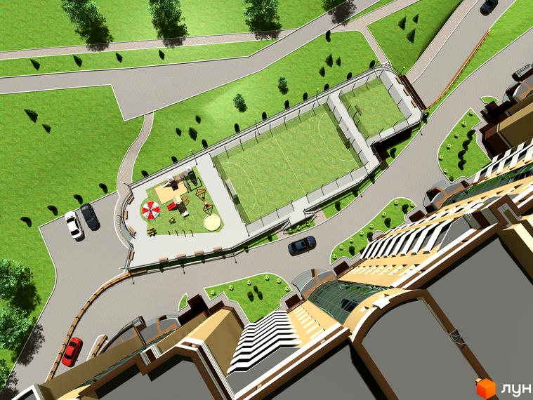 Житловий комплекс Europa Haus з висоти пташиного польоту. На зображенні видно багатоповерховий будинок з жовтою обробкою та скляним дахом, а також спортивний майданчик та дитячу зону.