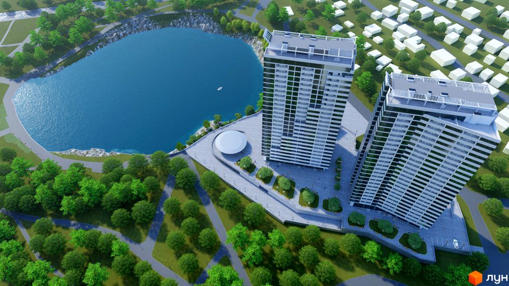 Дві високі житлові вежі Житлового комплексу Новокодацькi Вежi розташовані біля великого озера та паркової зони з деревами.