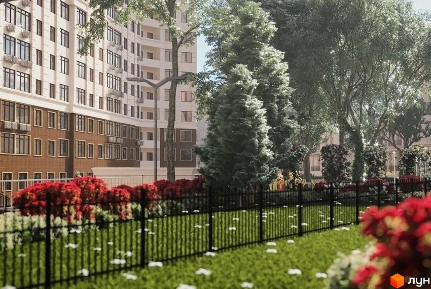 Зовнішній вигляд будинку в Житловому комплексі Тридцять перша перлина. Прибудинкова територія з газоном, квітами та огорожею.