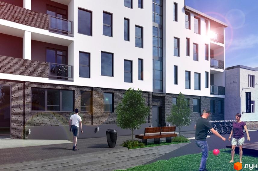 Новобудова на вулиці Богдана Хмельницького, 109, з цегляним фасадом та великими вікнами. На прибудинковій території розташовані лавки та дерева, де граються люди.