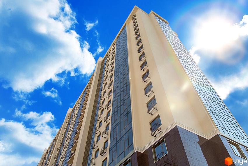 Новобудова Двадцята Перлина: високий житловий будинок з бежевим фасадом, скляними вікнами та балконами на тлі блакитного неба.