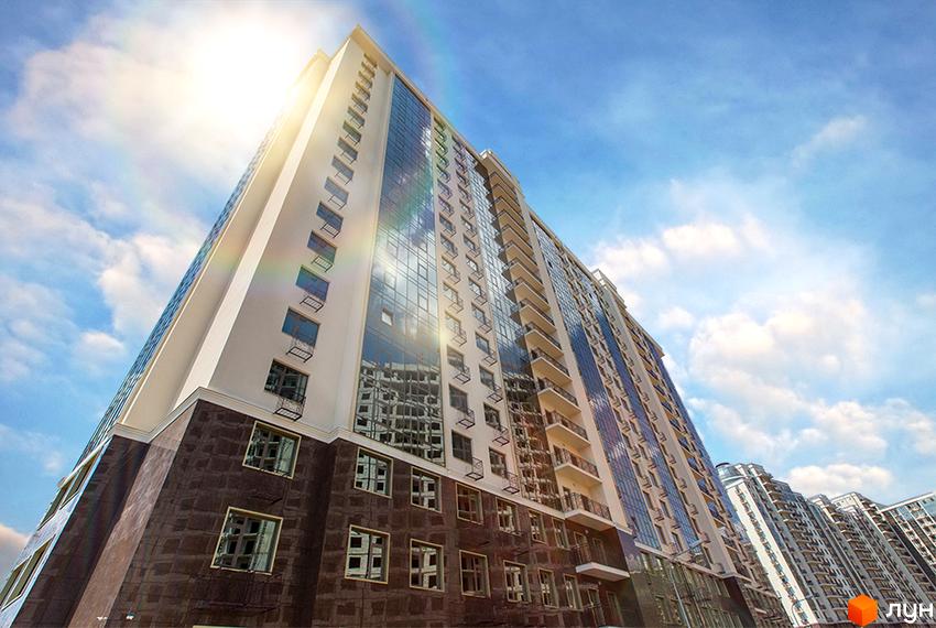 Житловий комплекс Двадцять перша Перлина: висотний будинок зі світлим фасадом, дзеркальними вікнами та балконами на тлі блакитного неба.