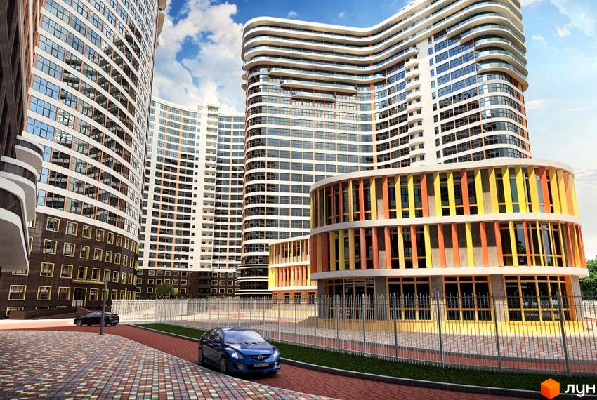 Житловий комплекс Сорок третя перлина. Зовнішній вигляд будівель з вигнутими фасадами та кольоровою оздобою нижнього поверху. Прибудинкова територія з дорогою та паркуванням.