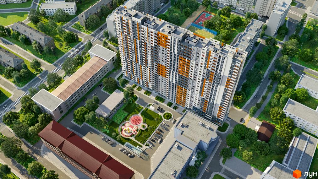 Вид згори на житловий комплекс Дніпровська Мрія з високою багатоповерхівкою та прибудинковою територією з дитячим майданчиком та парковкою.