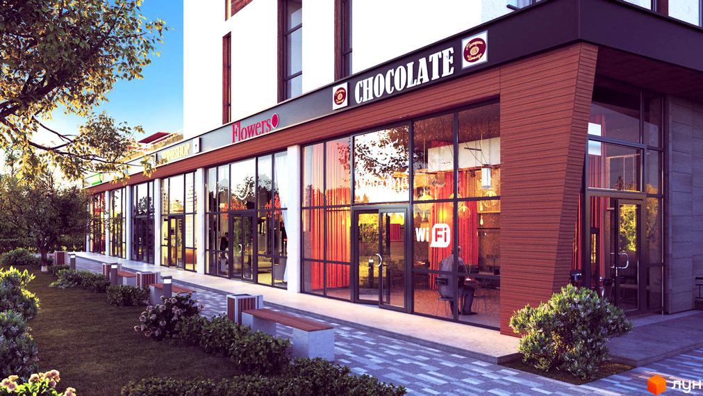 Зовнішній вигляд будівлі житлового комплексу Nyvky Plaza з великими вітринами та вивіскою «Chocolate». На передньому плані доглянута прибудинкова територія з лавками та газоном.