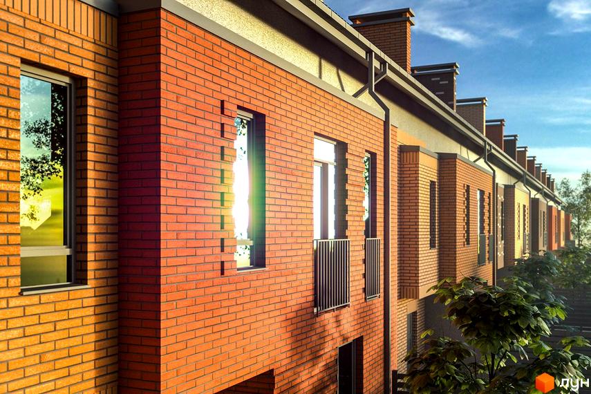 Таунхауси Sun House з червоної цегли під сонячним промінням. Зовнішній вигляд новобудови з вікнами та балконами.
