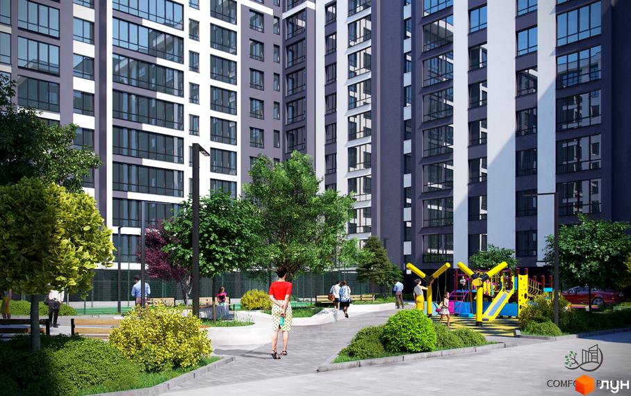 Житловий комплекс Comfort Park з сірими та білими фасадами, великими вікнами та зеленою прибудинковою територією з дитячим майданчиком.