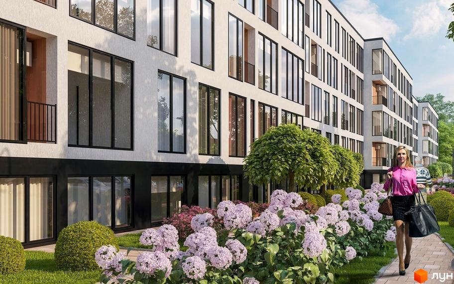 Зовнішній вигляд Житлового комплексу Kolibri з великими вікнами та білим фасадом. На передньому плані квітучі кущі та доглянута територія.