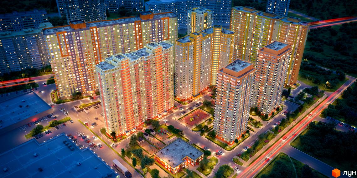 Житловий комплекс Яскравий у Києві. Багатоповерхові будинки з яскравими фасадами та підсвіченими вікнами, прибудинкова територія з дитячими майданчиками та парковкою.