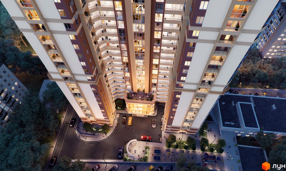 Вид зверху на новобудову ЖК Adamant з фасадом з коричневих та білих панелей. Прибудинкова територія з деревами, дорогою та зонами відпочинку.