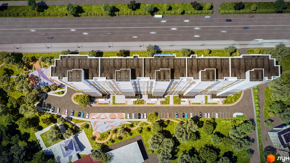 Аерофото Житлового комплексу Пектораль: довга будівля з білими фасадами та кольоровими акцентами, оточена зеленими зонами, дитячими майданчиками та парковками.