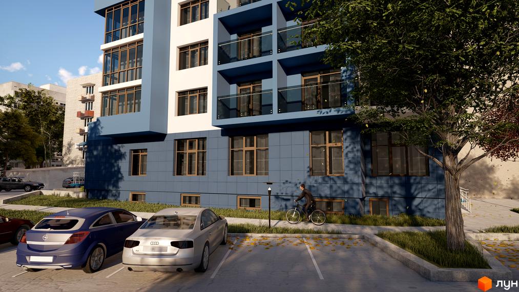 Новобудова ЖК LakePark з синьо-білим фасадом та скляними балконами. Поруч парковка з автомобілями та чоловік на велосипеді.