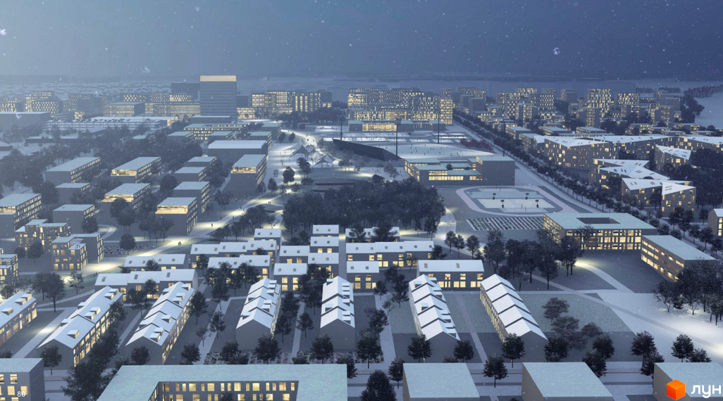 Житловий комплекс Vilne взимку: сучасні будинки з підсвіченими вікнами та засніжені дерева. Територія комплексу з доріжками та освітленням.