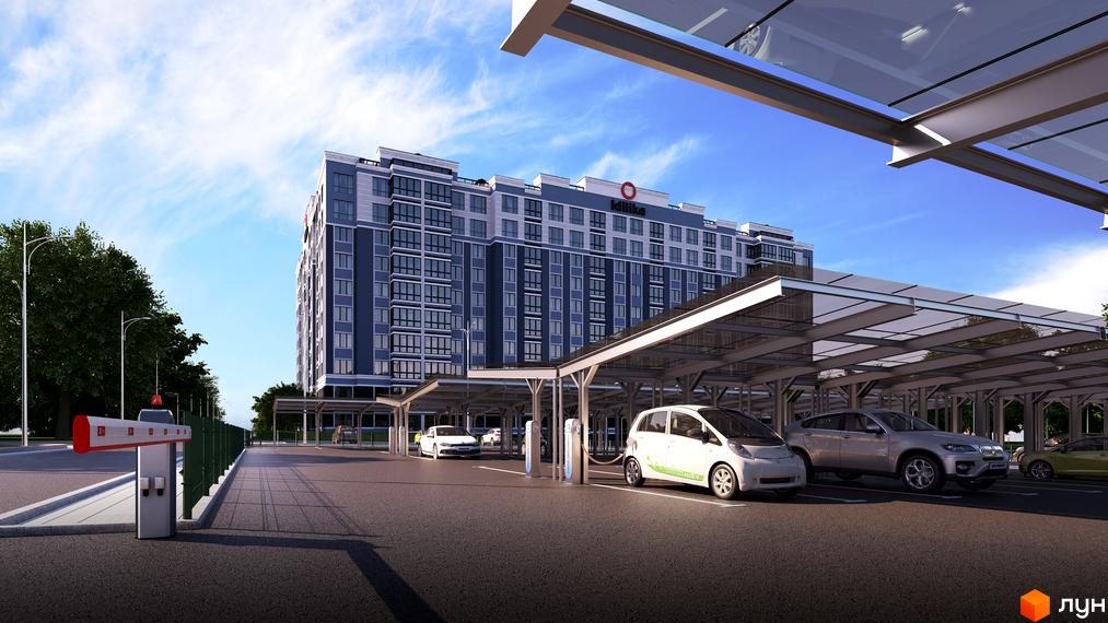 Зображення Житлового комплексу Idilika з парковкою для електромобілів. Фасад багатоповерхового будинку та зарядні станції на території.