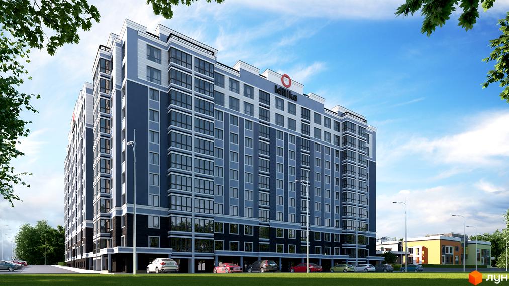 Житловий комплекс Idilika синьо-сірого кольору з великими вікнами. Перед будинком зелений газон, припарковані автомобілі та дерева.