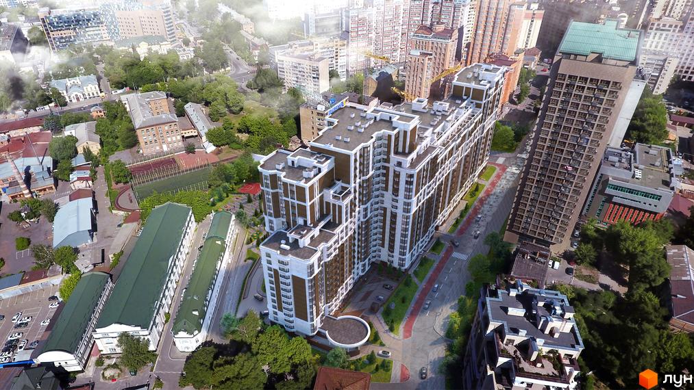 Вид з повітря на житловий комплекс Шевченківський з багатоповерховими будинками та прибудинковою територією з зеленими насадженнями та спортивними майданчиками.