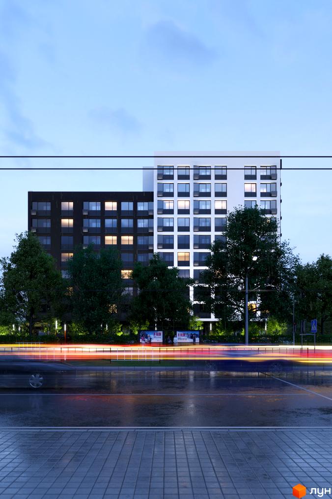 Житловий комплекс Avalon 2Day: двосекційний будинок з темним та світлим фасадами, освітлені вікна, мокра дорога з вогнями машин та дерева.