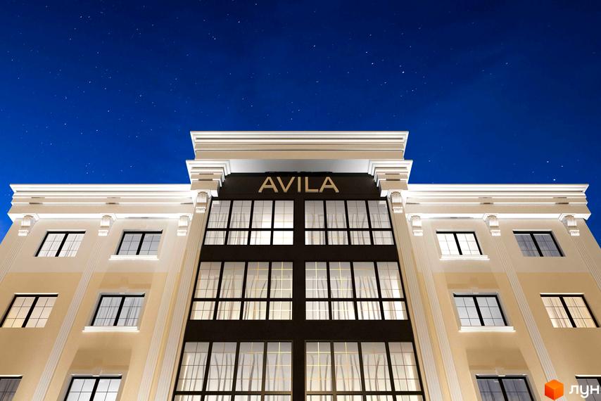 Зовнішній вигляд будинку Житлового комплексу Avila Lux вночі. Фасад будівлі з великими вікнами та написом на даху.