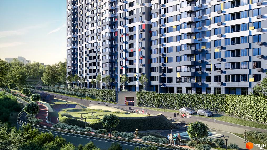 Житловий комплекс Кирилівський Гай: багатоповерховий будинок з сіро-білим фасадом та яскравими вставками, оточений зеленими зонами та доріжками.