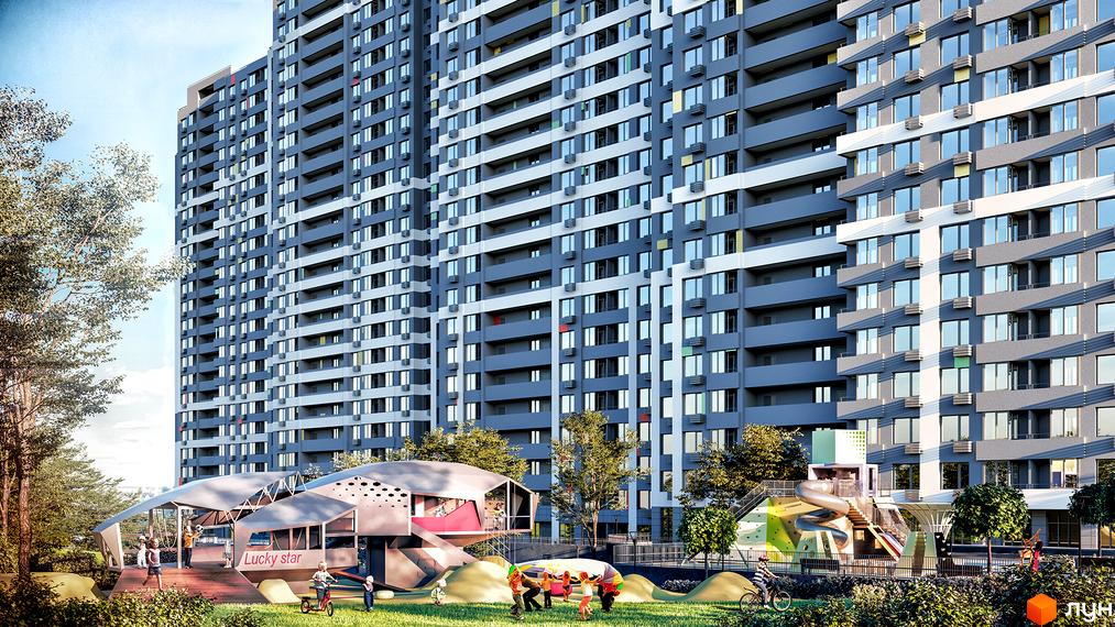 Фасад багатоповерхового будинку Житлового комплексу Кирилівський Гай має сірі та білі елементи, вікна та балкони. Поруч дитячий майданчик та зелені насадження.