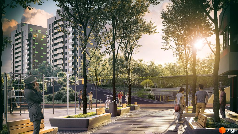 Новобудова Кирилівський Гай з багатоповерховими будинками сірого кольору з кольоровими акцентами. Навколо будівель облаштована територія з деревами, лавками та пішохідними доріжками.