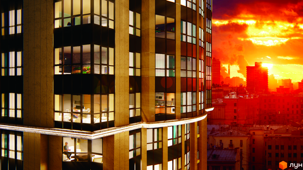 Висотна будівля ЖК Володимирський з панорамними вікнами на тлі заходу сонця. Навколо будинку розташовані інші будівлі та міська забудова.