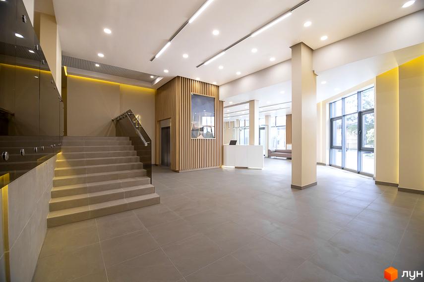 Інтер'єр холу житлового комплексу White Tower з сходами, ліфтом та зоною ресепшн. Сучасний дизайн та функціональне планування.