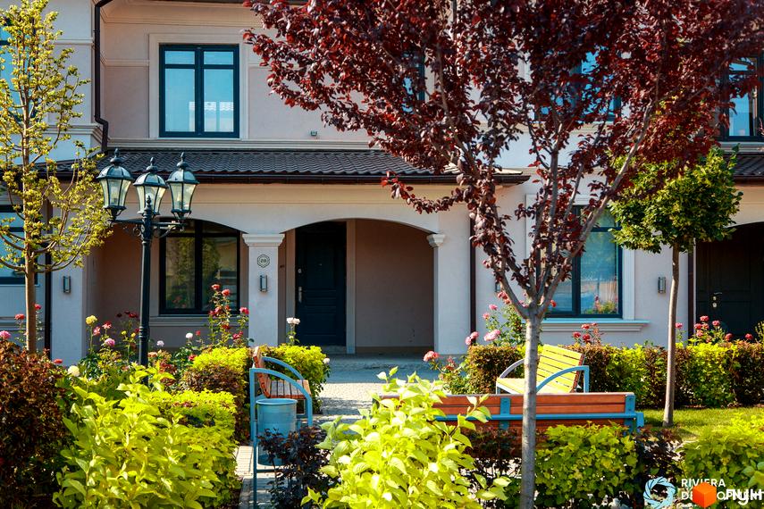 Зовнішній вигляд таунхаусів Вілла Троянд з квітучою прибудинковою територією та зеленими насадженнями.