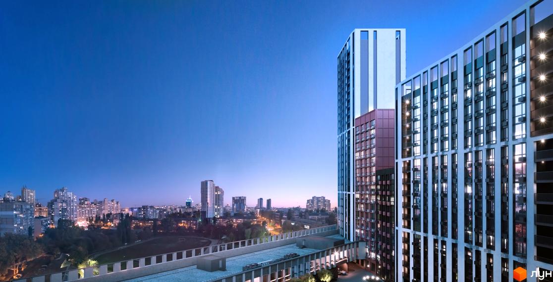 Житловий комплекс Старт: вечірній вигляд висотних будинків з освітленими вікнами та панорамою міста з парком.